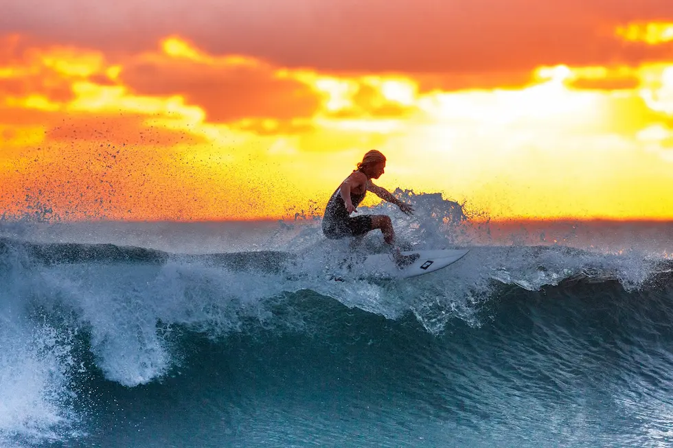 Billede af en mand med gode vaner der surfer på havet